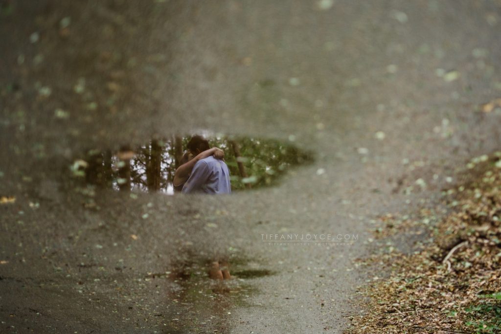 Reflection of couple in puddle during Ledyard engagement session in CT