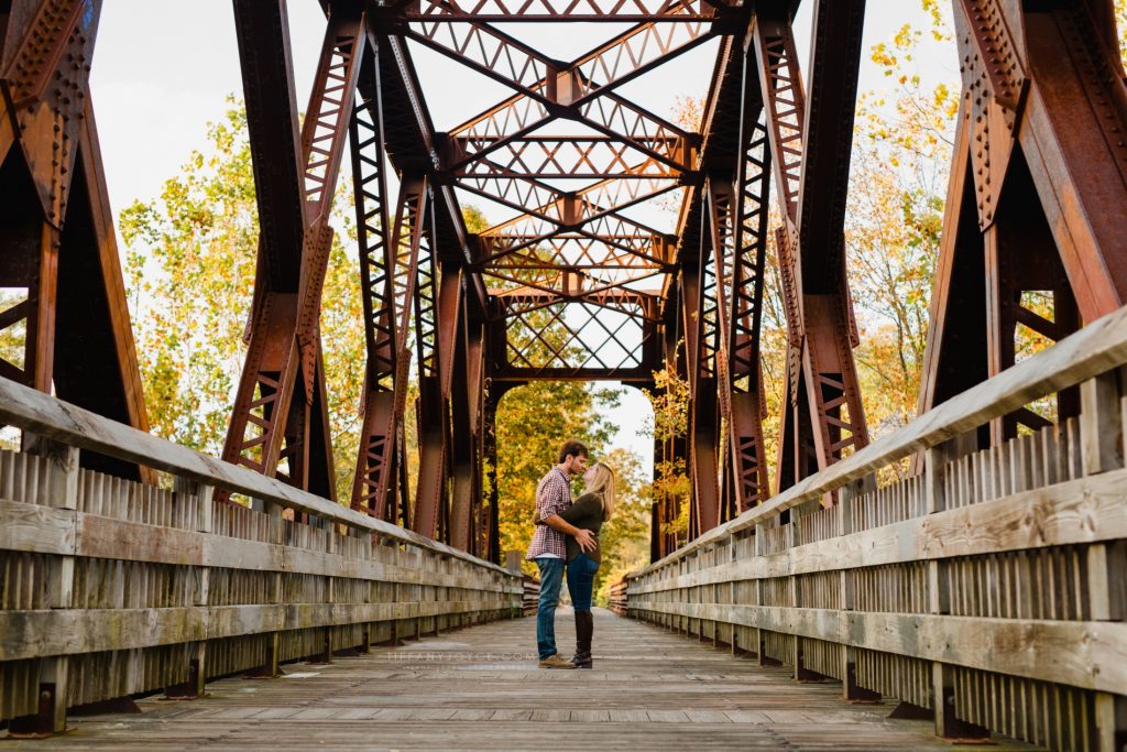Couple kissing on bridge during Collinsville CT engagement session.