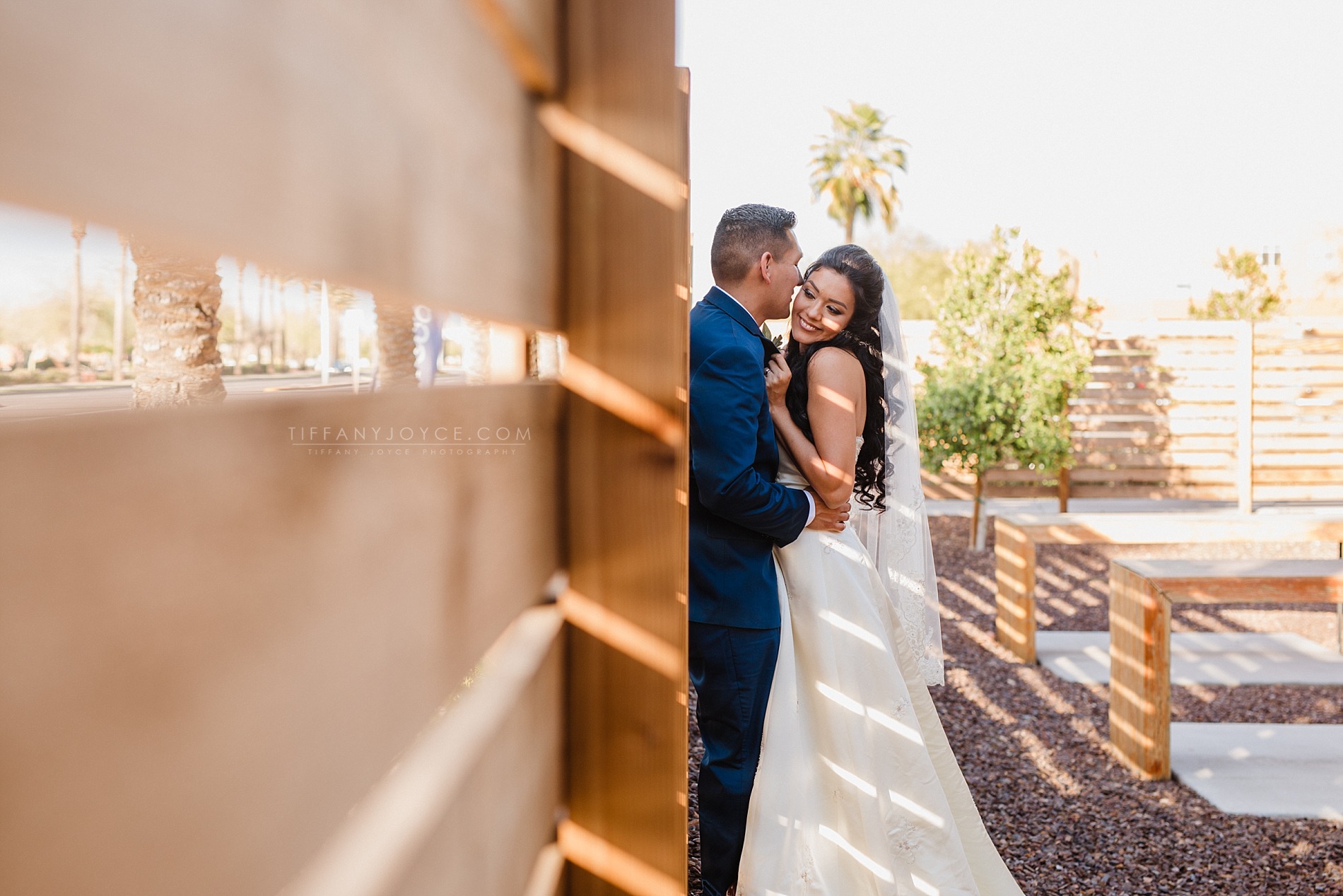 Couple snuggling against wall at downtown phoenix wedding